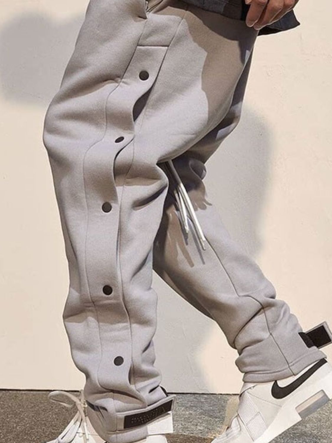 Trendsi comfortable men's pants in light gray with button details and drawstring for a stylish look.