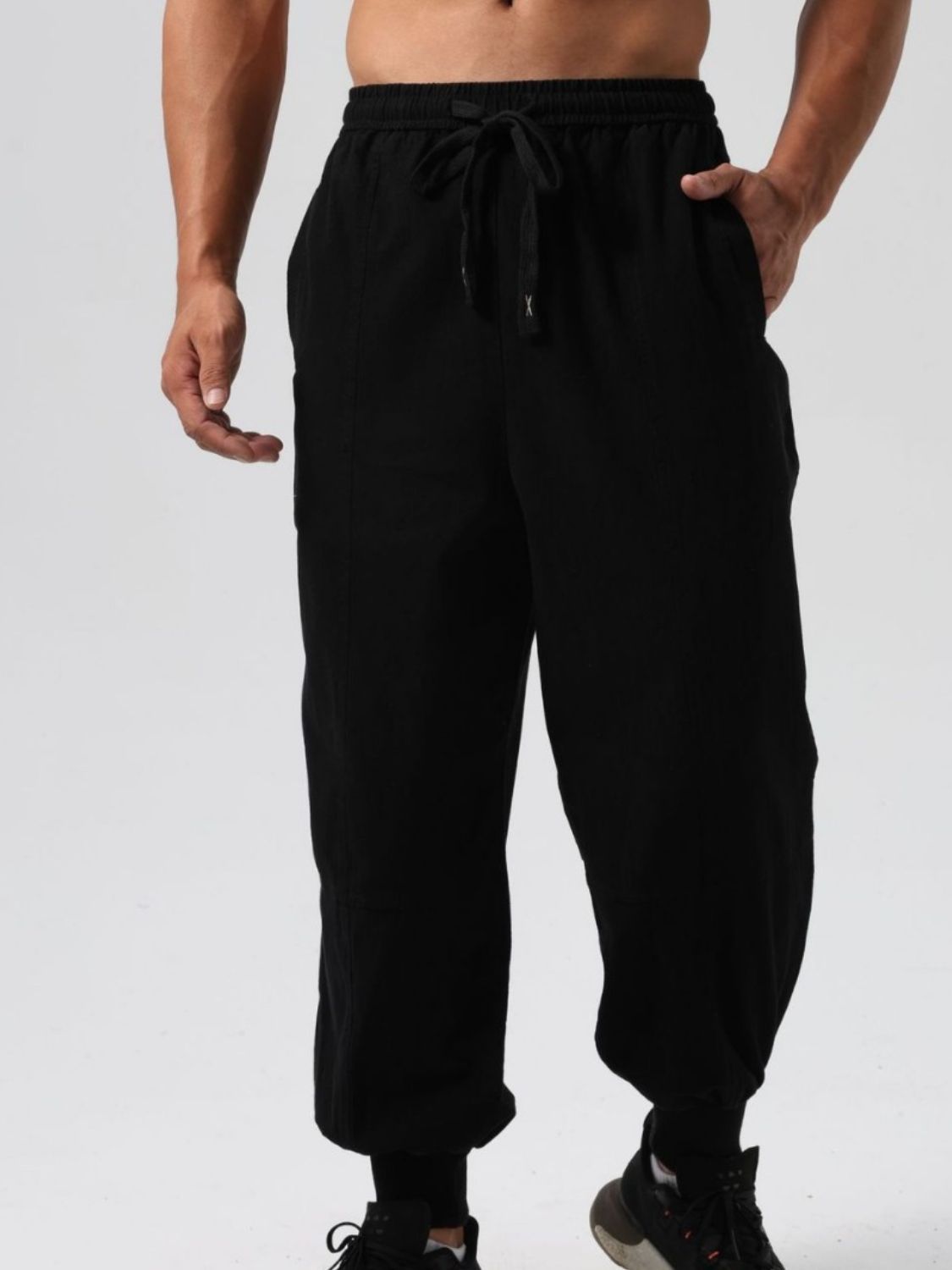Men's casual jogging pants in black with elastic drawstring waist and side pockets for comfort