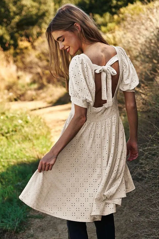 Trendsi romantic eyelet baby doll dress with back tie detail and puff sleeves for a flirty look