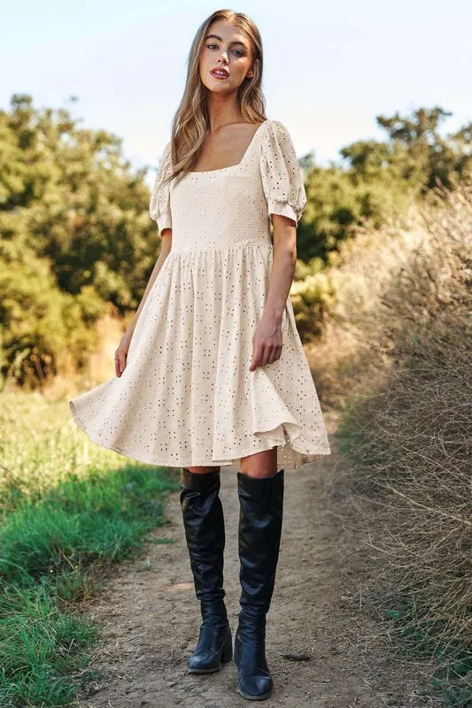 Trendsi romantic eyelet baby doll dress in beige with puff sleeves and flowy design, perfect for casual outings