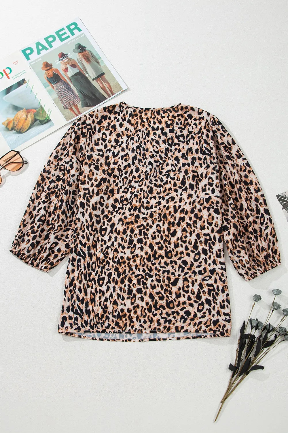 Back view of a stylish leopard print top with long balloon sleeves and a relaxed fit