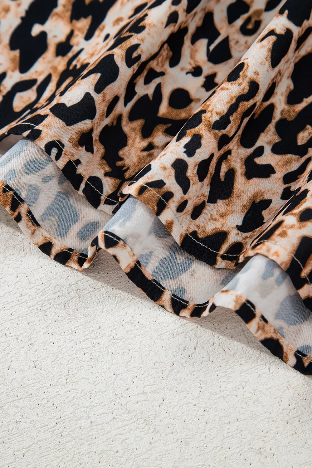 Close-up of the stylish leopard print top showcasing its soft fabric and vibrant patterns