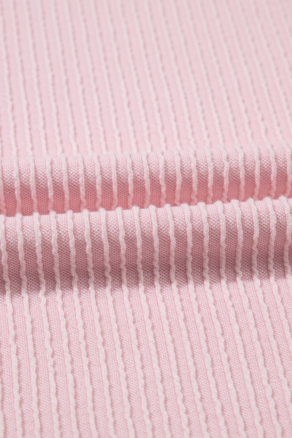 Close-up of soft pink fabric texture for trendy casual shirts with ribbed design