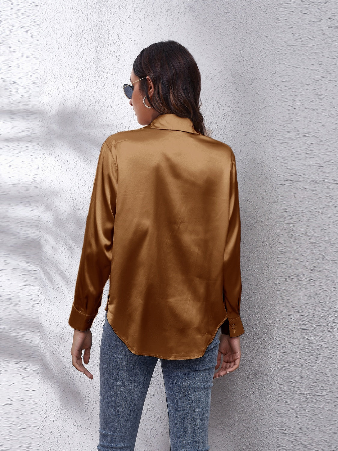 Back view of a woman wearing an affordable long sleeve shirt in brown with sleek design and relaxed fit