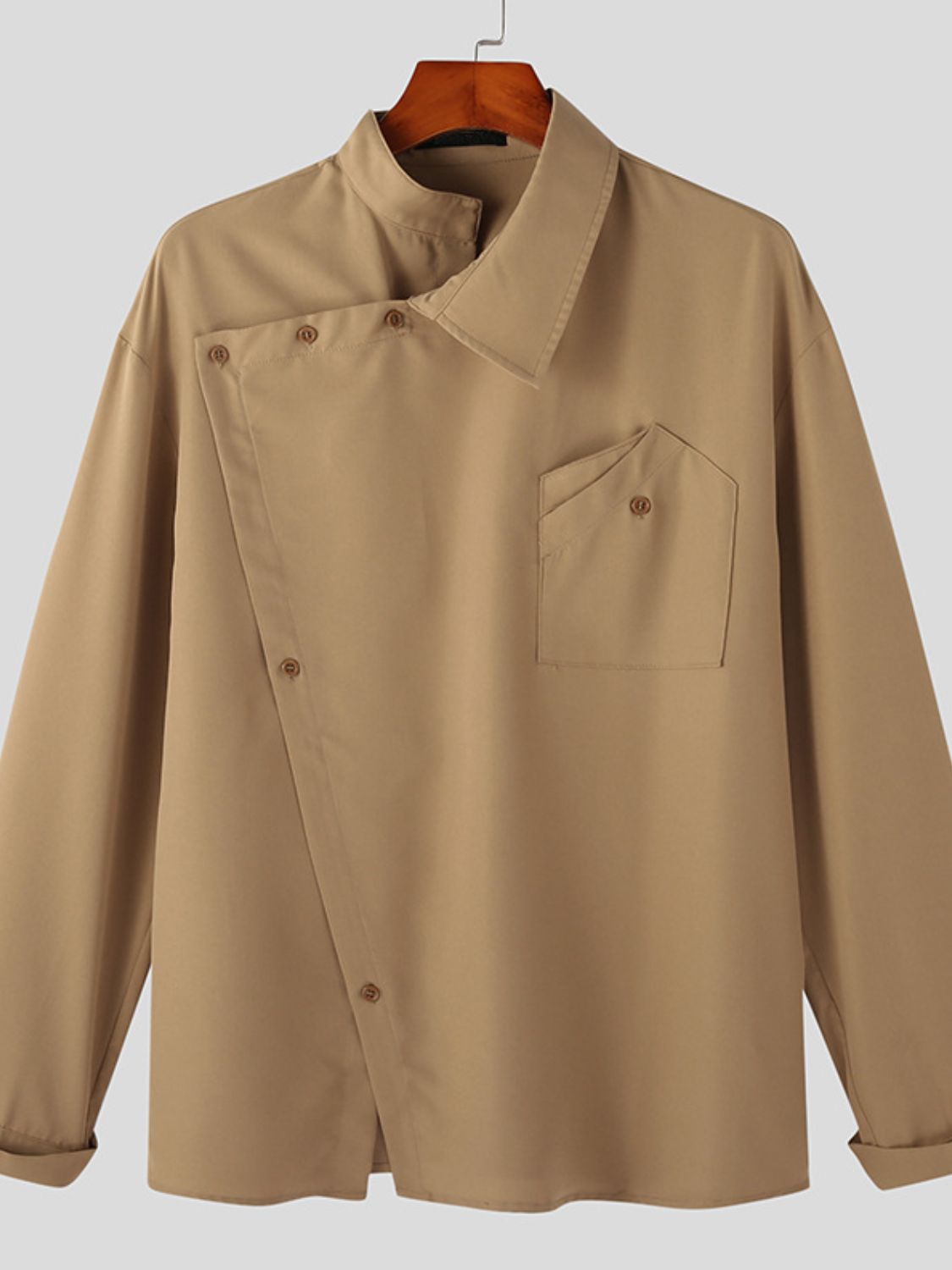 asymmetrical long sleeve shirt in beige with a unique buttoned design and front pocket