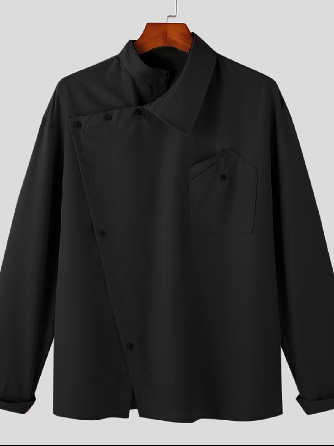 asymmetrical long sleeve shirt in black with unique button design and pocket detail