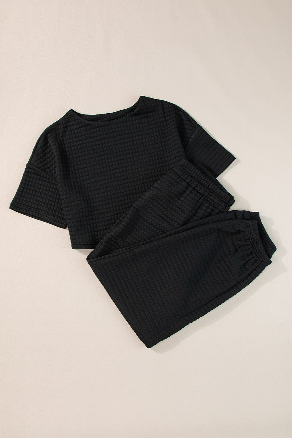 Black waffle patterned casual summer outfit featuring a loose-fit top and matching pants