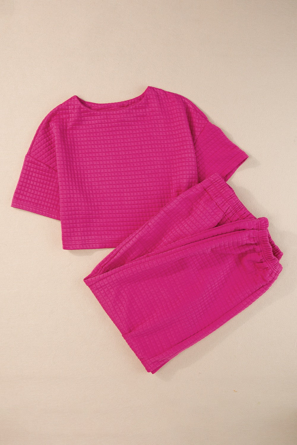Bright pink casual summer outfit featuring a cropped top and matching shorts for a trendy look
