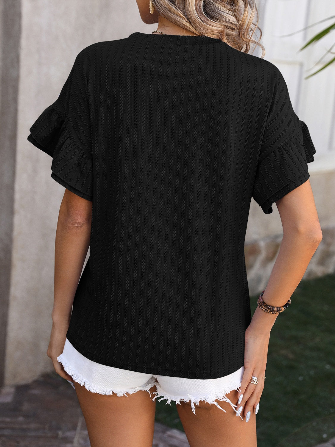 Black ruffled short sleeve blouse with a relaxed fit, perfect for casual summer outings