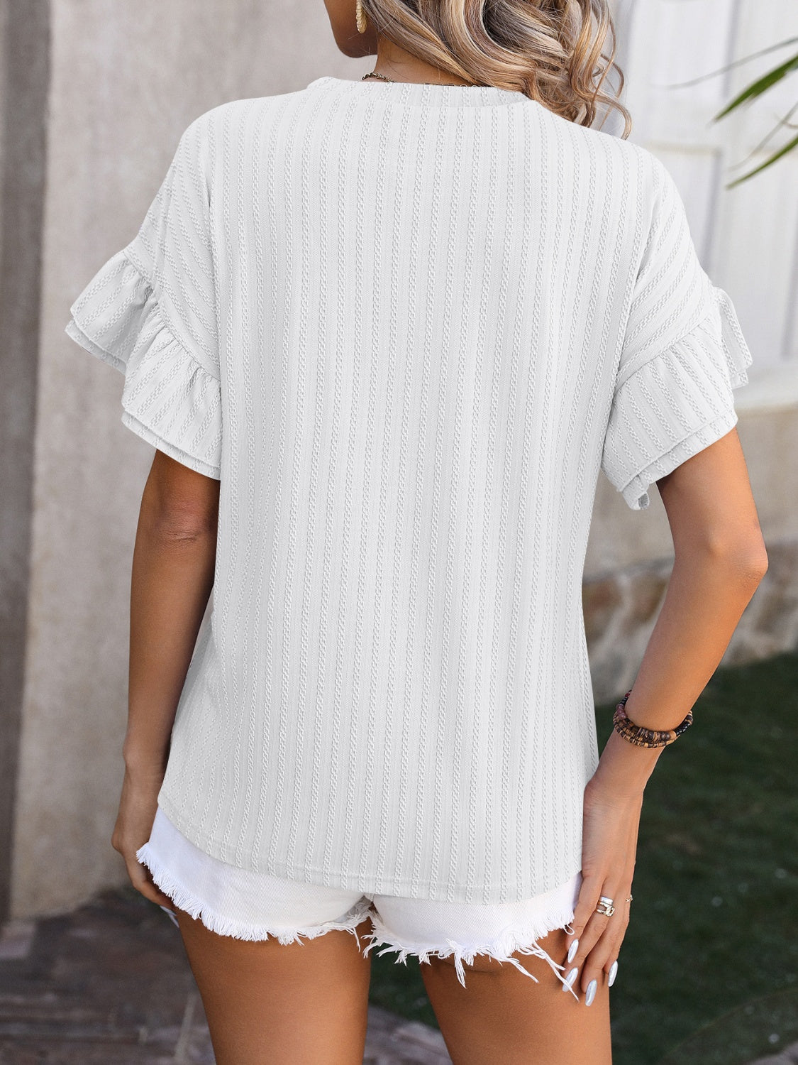 Trendsi ruffled short sleeve blouse in light color, featuring soft fabric and stylish short sleeves