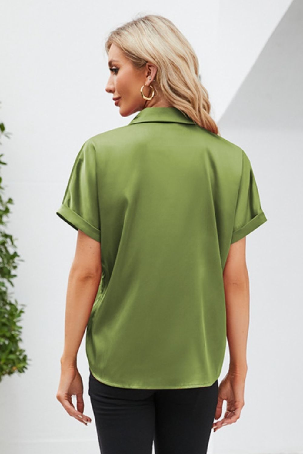 Back view of a green short sleeve casual shirt with rolled sleeves and a relaxed fit