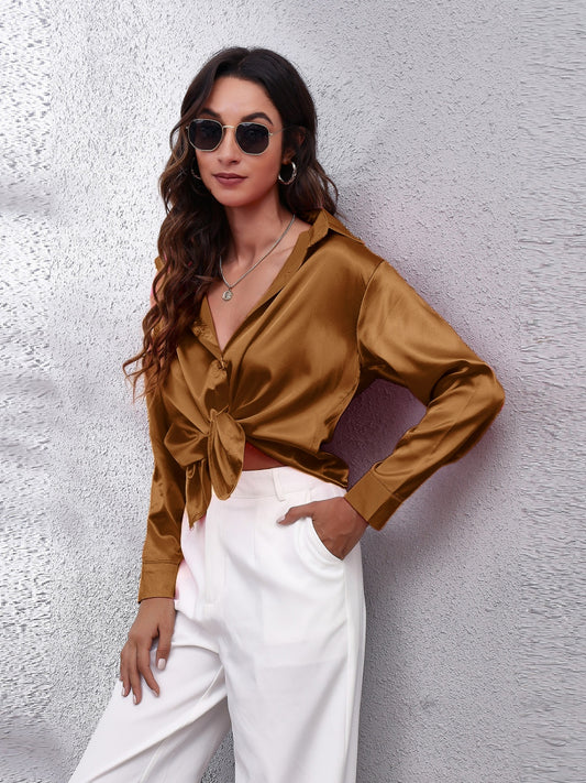 Trendy woman in a brown affordable long sleeve shirt styled with white pants and sunglasses